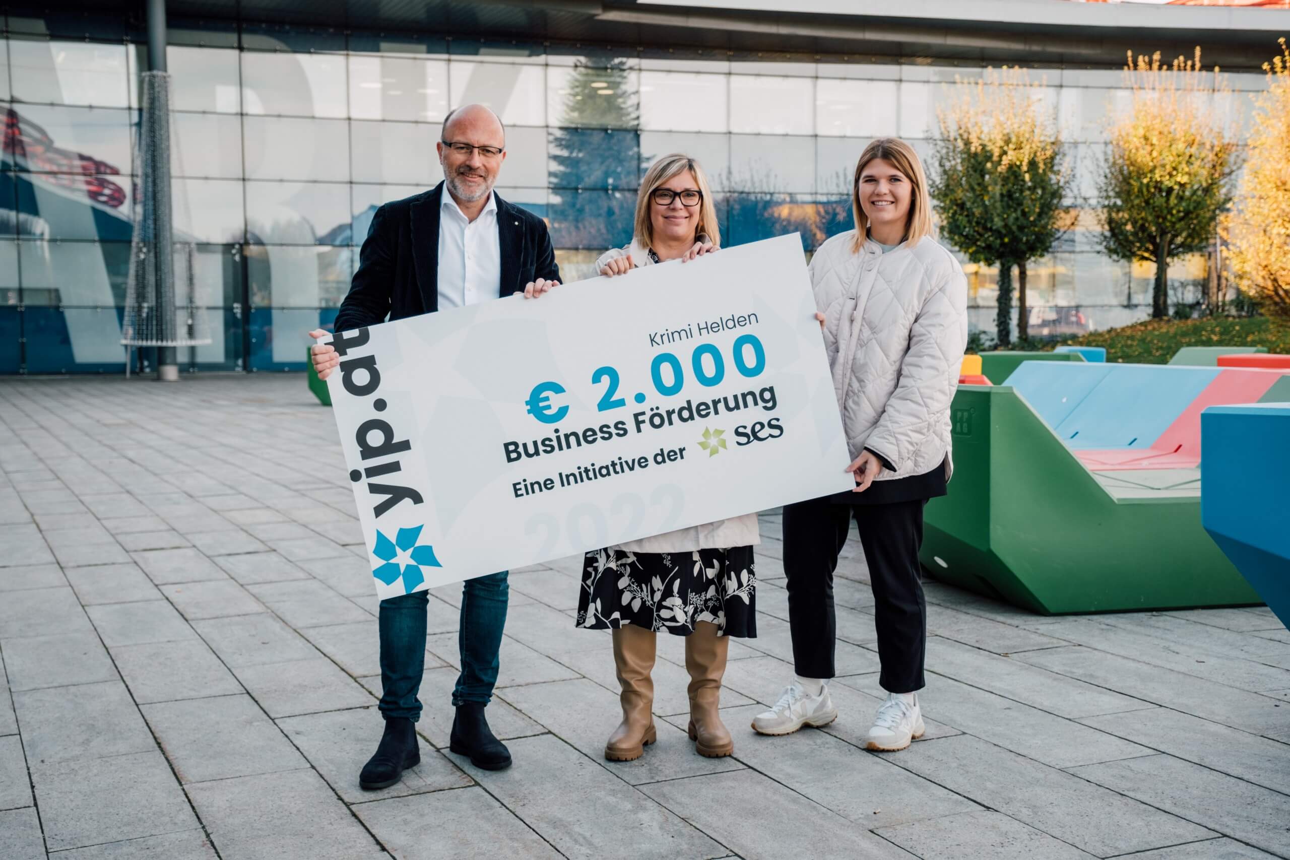 Drei Menschen die eine yip.at Business-Förderungs-Urkunde in die Kamera halten